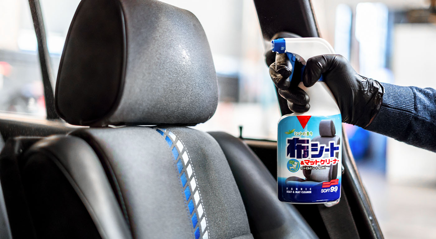 Soft99 interior car care product Fabric Seat Cleaner being sprayed on a car seat.
